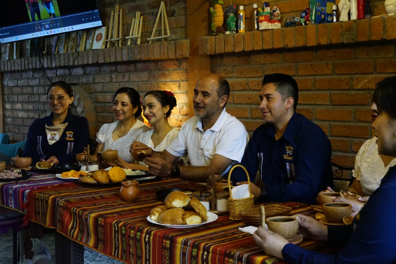 Editorial documentary photograph representing cultural management in Ecuador — a cultural event, community gathering, or heritage conservation work in an Ecuadorian context. Warm earth tones, natural light, authentic atmosphere. No generic stock feel. Sophisticated and contemporary aesthetic. Conveys territorial identity, cultural depth, and community engagement.